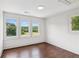Bedroom featuring neutral colors, hardwood floors, and bright natural light at 4935 Stablegate Ct, Cumming, GA 30028
