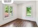 Bedroom 2 offers ample natural light and hardwood flooring at 4935 Stablegate Ct, Cumming, GA 30028
