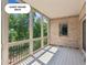 A screened-in deck with a brick facade provides an outdoor space with views of the grounds at 4935 Stablegate Ct, Cumming, GA 30028