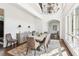 Dining room with high ceilings, chandelier, large table, and views of the front yard at 4935 Stablegate Ct, Cumming, GA 30028