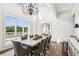 Dining room with floor-to-ceiling windows, chandelier, and a large wood table at 4935 Stablegate Ct, Cumming, GA 30028