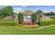 Stone entrance to Ascot community with manicured landscaping and signature signage at 4935 Stablegate Ct, Cumming, GA 30028
