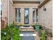 Charming front entrance with brick facade, decorative plants, and a stone pathway leading to the front door at 4935 Stablegate Ct, Cumming, GA 30028