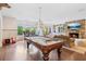 Spacious game room with a pool table, fireplace, hardwood floors, and natural light at 4935 Stablegate Ct, Cumming, GA 30028