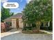 Separate guest house with a brick exterior, stone pathway, and a lush landscaped front yard at 4935 Stablegate Ct, Cumming, GA 30028