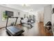 Large, naturally-lit home gym featuring a treadmill, rowing machine, and weight rack at 4935 Stablegate Ct, Cumming, GA 30028
