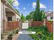 Brick gated driveway with a view of the herb garden leading to the main house and guest house at 4935 Stablegate Ct, Cumming, GA 30028