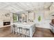 Spacious kitchen with a central island, cozy fireplace, and ample countertop space at 4935 Stablegate Ct, Cumming, GA 30028