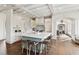 Open-concept kitchen featuring a large island with seating, custom cabinetry, and hardwood floors at 4935 Stablegate Ct, Cumming, GA 30028