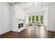 Living room with fireplace, hardwood floors, picture windows and neutral paint at 4935 Stablegate Ct, Cumming, GA 30028