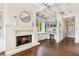 Living room with fireplace, hardwood floors, a built-in desk, and white shelving at 4935 Stablegate Ct, Cumming, GA 30028