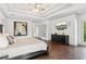 Spacious main bedroom boasts hardwood floors, tray ceiling, and a mounted television at 4935 Stablegate Ct, Cumming, GA 30028