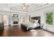 Large main bedroom with fireplace, hardwood floors, and views of outside at 4935 Stablegate Ct, Cumming, GA 30028
