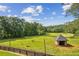 Aerial view of a green pasture including three cows and a well maintained shed at 4935 Stablegate Ct, Cumming, GA 30028