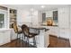 Charming wet bar features white cabinetry, built-in wine rack, dark countertops, and stainless fixtures at 4935 Stablegate Ct, Cumming, GA 30028