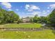 Beautifully landscaped yard with pasture, shed, and a well maintained house at 4935 Stablegate Ct, Cumming, GA 30028