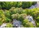 Aerial view of home with mature trees surrounding the property and a river nearby at 920 Waters Reach Ct, Alpharetta, GA 30022
