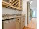 Wet bar featuring granite countertops, custom cabinetry, and a wine rack at 920 Waters Reach Ct, Alpharetta, GA 30022