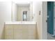 Well-lit bathroom featuring a white vanity with drawers and cabinets, and a large mirror for convenience at 920 Waters Reach Ct, Alpharetta, GA 30022