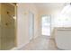 Bright bathroom featuring a glass shower, white vanity, and neutral tile flooring for a clean, classic look at 920 Waters Reach Ct, Alpharetta, GA 30022