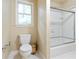 Functional bathroom with a toilet, window, and shower with sliding glass door, efficiently designed and clean at 920 Waters Reach Ct, Alpharetta, GA 30022