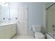 Cozy bathroom with a white vanity, toilet, and shower featuring a sliding glass door with neutral design elements at 920 Waters Reach Ct, Alpharetta, GA 30022
