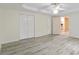 Large bedroom with ample closet space, light hardwood flooring, and a modern ceiling fan at 920 Waters Reach Ct, Alpharetta, GA 30022