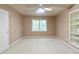 Neutral bedroom with ceiling fan, built-in shelving, and natural light from a window, offering a calm space at 920 Waters Reach Ct, Alpharetta, GA 30022