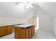 Bonus room with an island, built in counterspace and lots of storage cabinets, ceiling fan, and lots of light at 920 Waters Reach Ct, Alpharetta, GA 30022
