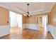 Dining area featuring hardwood floors, wainscoting, and a view of a built-in cabinet through double doors at 920 Waters Reach Ct, Alpharetta, GA 30022
