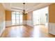 Elegant dining area with hardwood floors, large windows, and wainscoting showcasing classic design at 920 Waters Reach Ct, Alpharetta, GA 30022