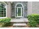 Inviting entrance with a brick and stone facade, decorative glass door and well-maintained landscaping at 920 Waters Reach Ct, Alpharetta, GA 30022