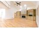 Bright living room featuring a stone fireplace flanked by custom built-ins and hardwood flooring at 920 Waters Reach Ct, Alpharetta, GA 30022