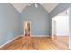 Spacious living room with hardwood floors, vaulted ceiling, and entryways creating a versatile layout at 920 Waters Reach Ct, Alpharetta, GA 30022