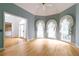 Open living room with hardwood floors, large windows, and neutral walls creating a bright and airy space at 920 Waters Reach Ct, Alpharetta, GA 30022