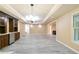 Open-concept living room with built-in cabinets and stainless steel refrigerator at 920 Waters Reach Ct, Alpharetta, GA 30022
