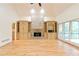 Bright living room featuring a stone fireplace flanked by custom built-ins and hardwood flooring at 920 Waters Reach Ct, Alpharetta, GA 30022