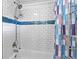 The renovated bathroom features a tiled shower with blue accent tiles, and contemporary fixtures at 108 Fountain Oak, Villa Rica, GA 30180