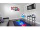 Gaming bedroom featuring a modern gray sofa, desk, neon art and hardwood floors at 108 Fountain Oak, Villa Rica, GA 30180