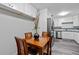 A charming dining area with hardwood table and seating adjacent to a stainless steel refrigerator at 108 Fountain Oak, Villa Rica, GA 30180
