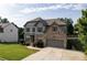 Inviting two-story home with gray siding, brick details, manicured lawn, and a two-car garage at 108 Fountain Oak, Villa Rica, GA 30180