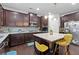 Updated kitchen featuring dark wood cabinets, granite countertops, stainless steel appliances, and a center island with seating at 108 Fountain Oak, Villa Rica, GA 30180
