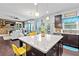 Open concept kitchen with dark cabinets, granite countertops, a center island, and an adjacent living area at 108 Fountain Oak, Villa Rica, GA 30180