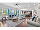 Spacious living room with hardwood floors, large windows, comfortable seating, and an open view to the kitchen at 108 Fountain Oak, Villa Rica, GA 30180