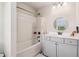 Cozy bathroom features a shower-tub combo and a single sink vanity with storage at 1564 Brunswick St, Douglasville, GA 30135