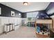 Playful bedroom with dark walls features a bunk bed, carpeted floors, and a large window at 1564 Brunswick St, Douglasville, GA 30135