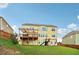 Spacious backyard featuring a deck, slide and swing set with a backdrop of the home's rear elevation at 1564 Brunswick St, Lithia Springs, GA 30122