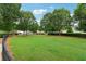 Beautiful common green space surrounded by mature trees perfect for neighborhood activities at 1564 Brunswick St, Lithia Springs, GA 30122