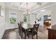 Bright dining room featuring coffered ceilings, wainscoting, and dark wood floors for elegant meals and gatherings at 1564 Brunswick St, Lithia Springs, GA 30122