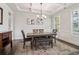 Formal dining room with coffered ceilings, wainscoting, modern chandelier, and hardwood floors at 1564 Brunswick St, Lithia Springs, GA 30122